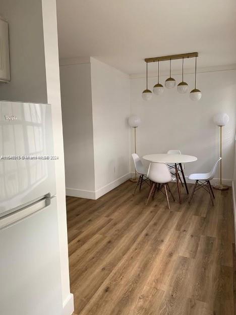 a view of a room with a table and chairs