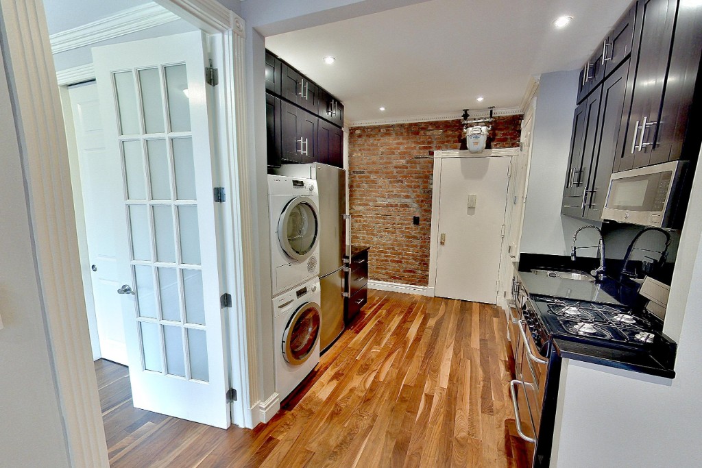 a kitchen with refrigerator a washer and dryer