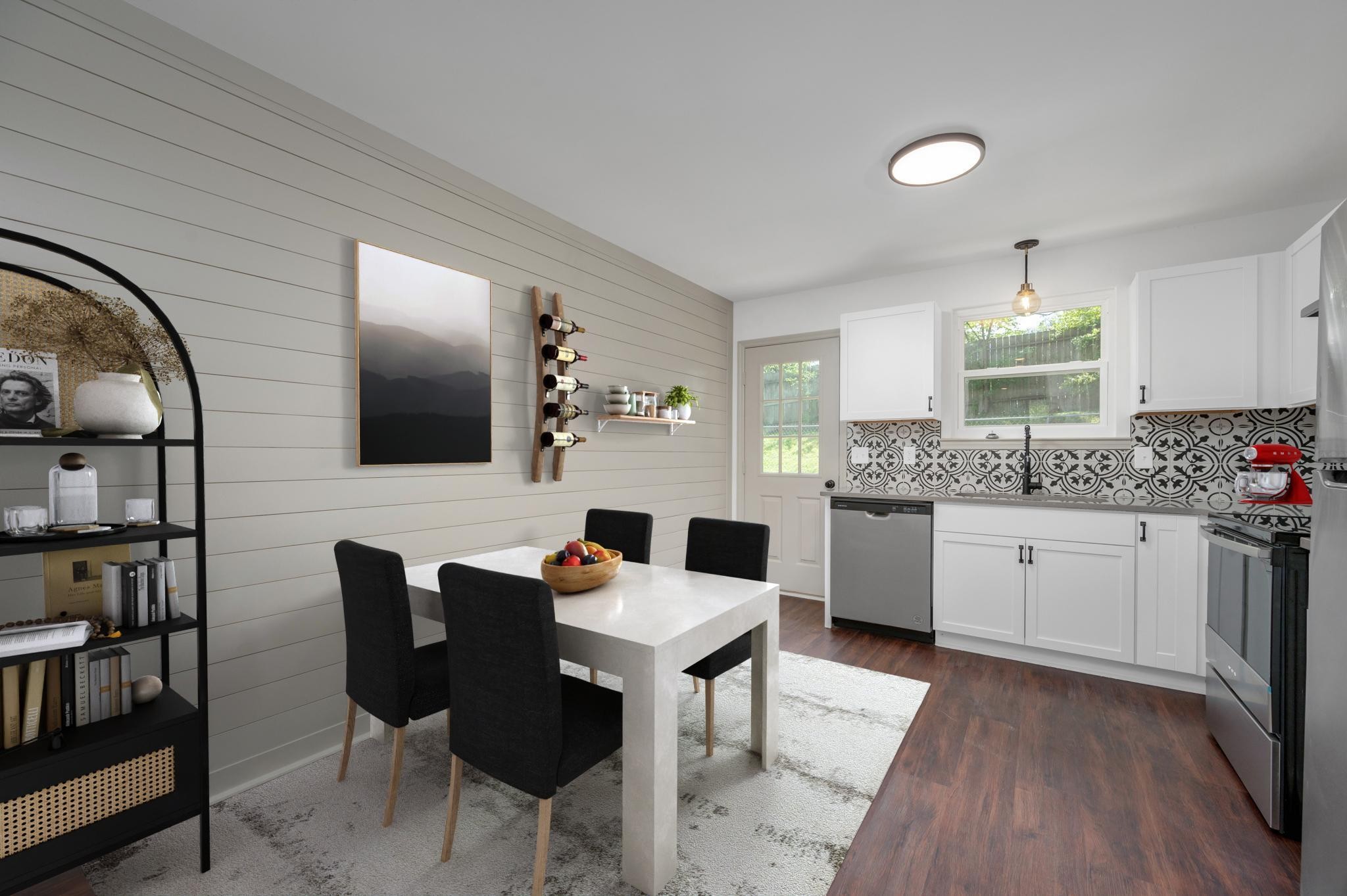 a kitchen with a dining table chairs and white cabinets