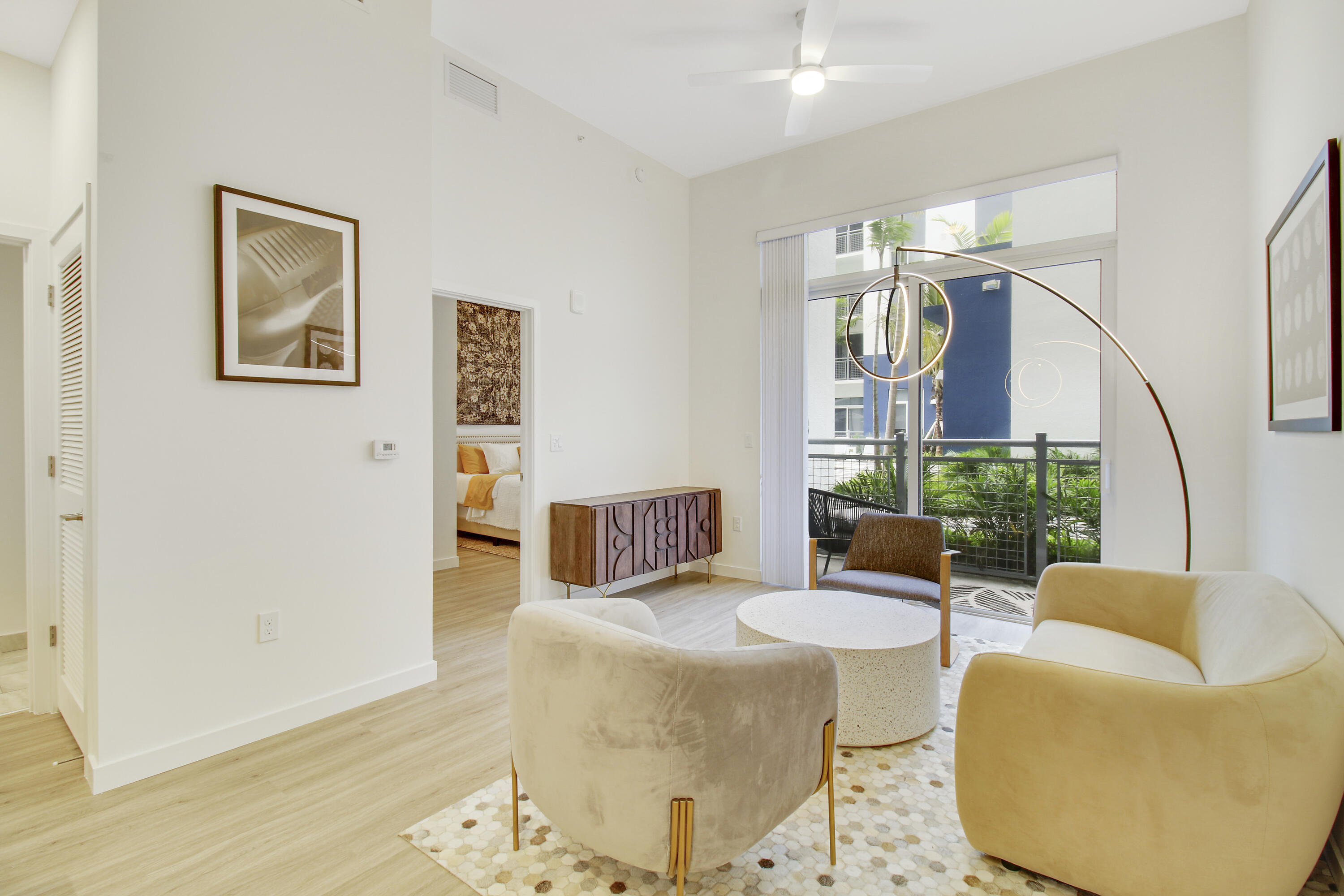 a living room with furniture and wooden floor