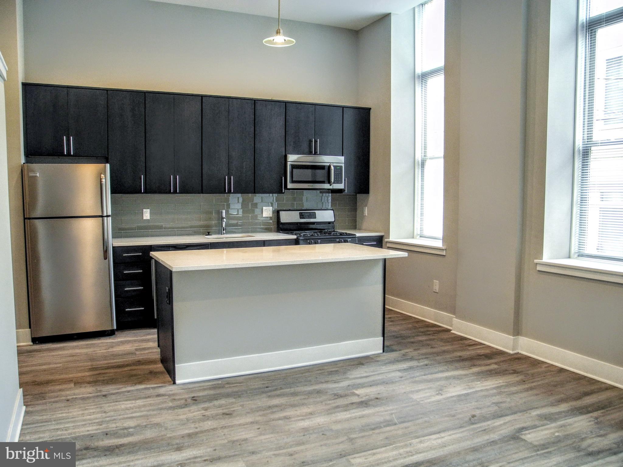 a kitchen with wooden cabinets and stainless steel appliances