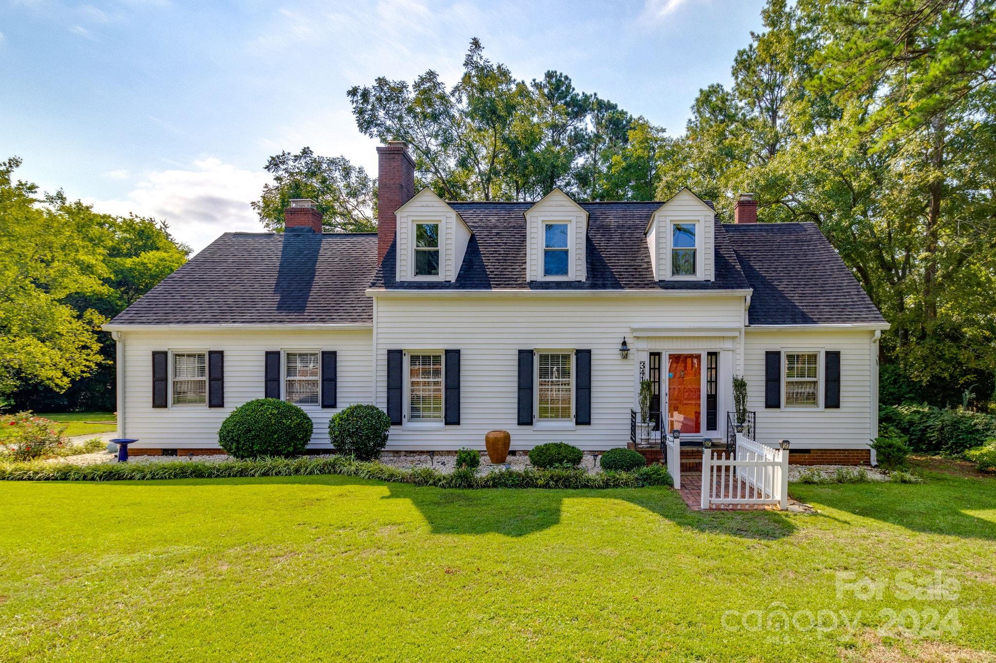 a front view of house with yard and green space