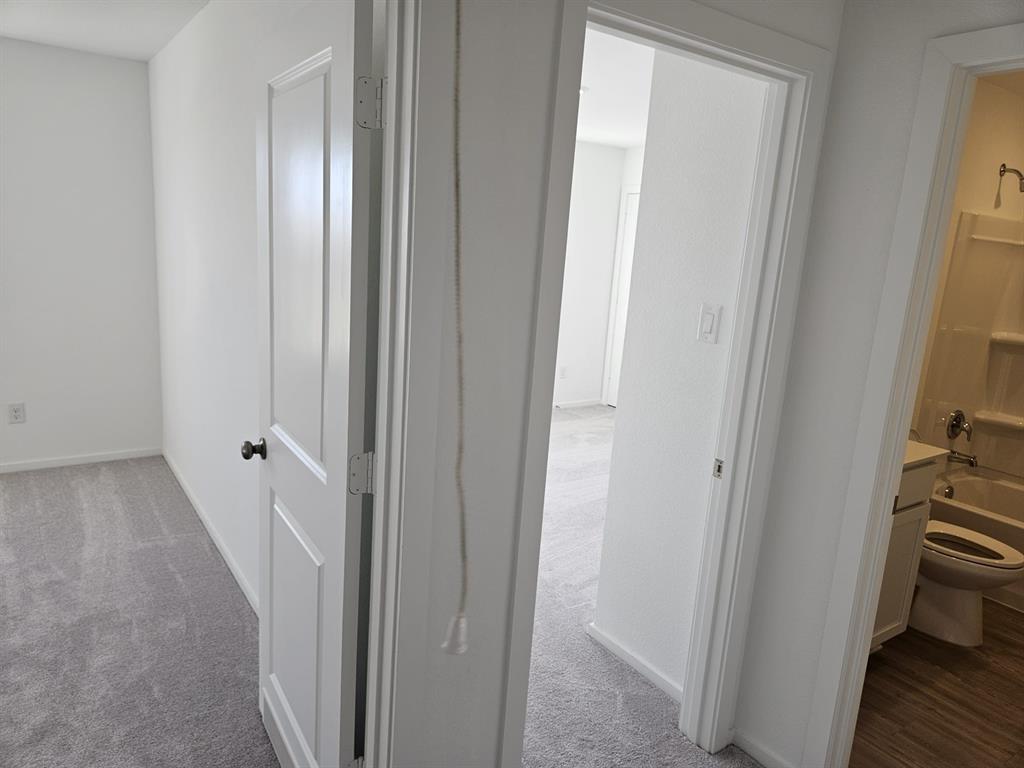 a view of a bathroom from a hallway