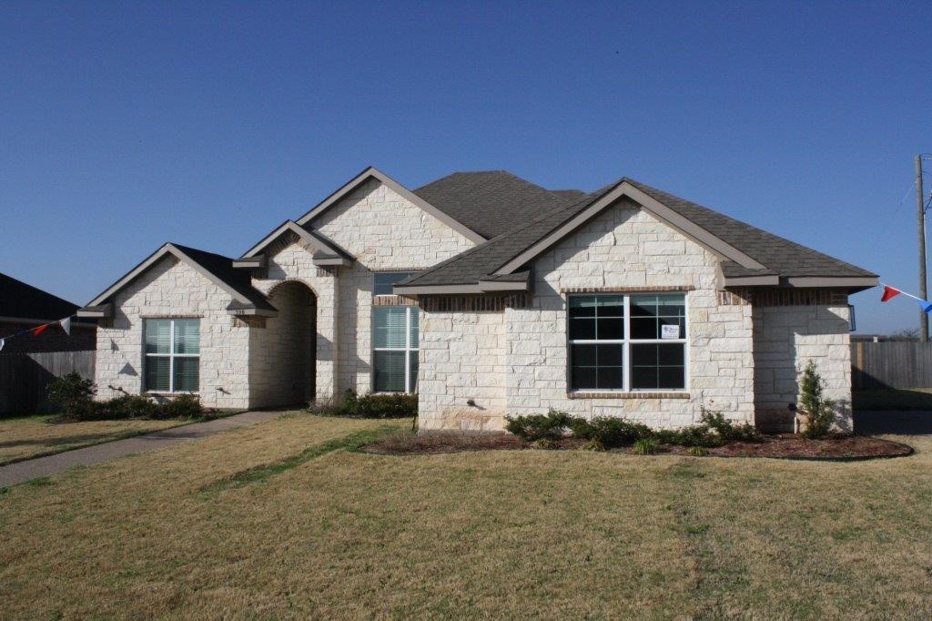 front view of a house with a yard