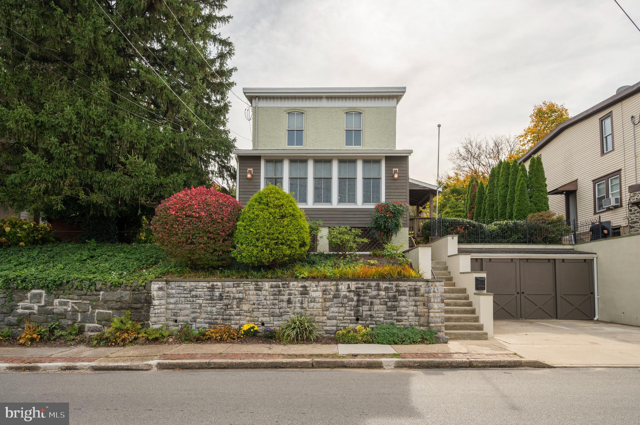 a front view of a house with a garden