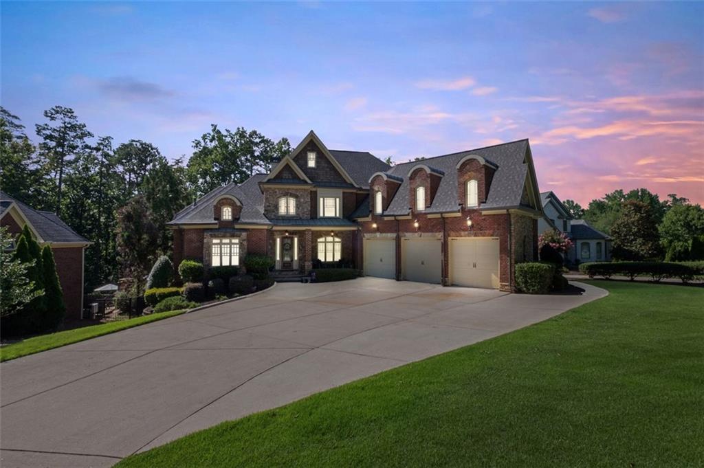 a front view of a house with a garden and yard