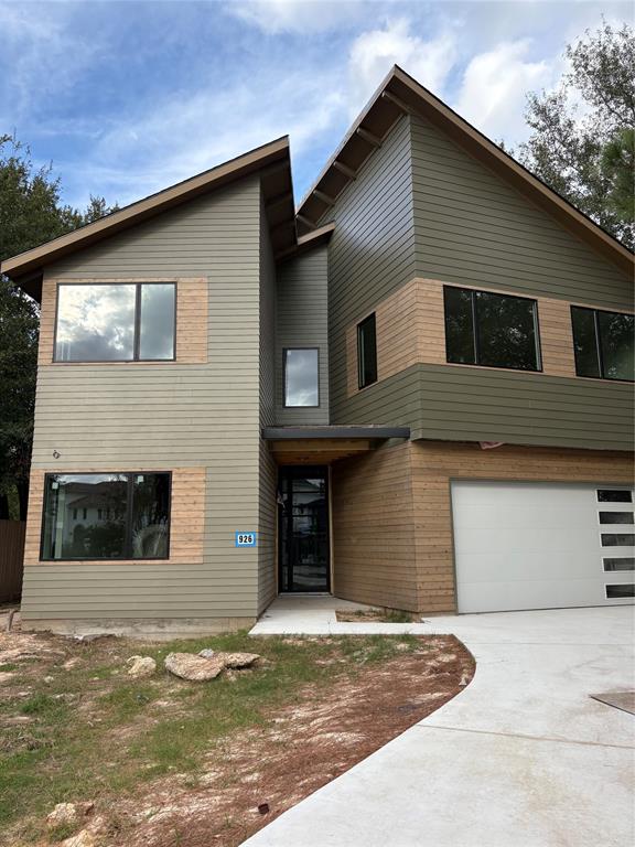 a front view of a house with garage