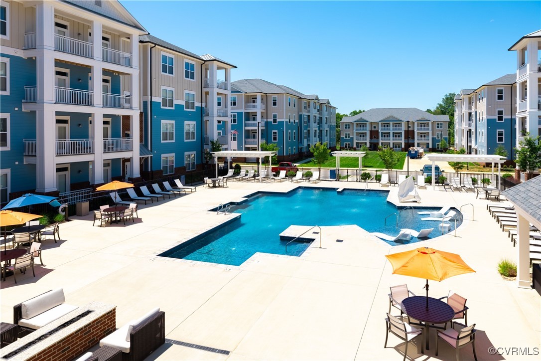 a view of a swimming pool and lounge chairs