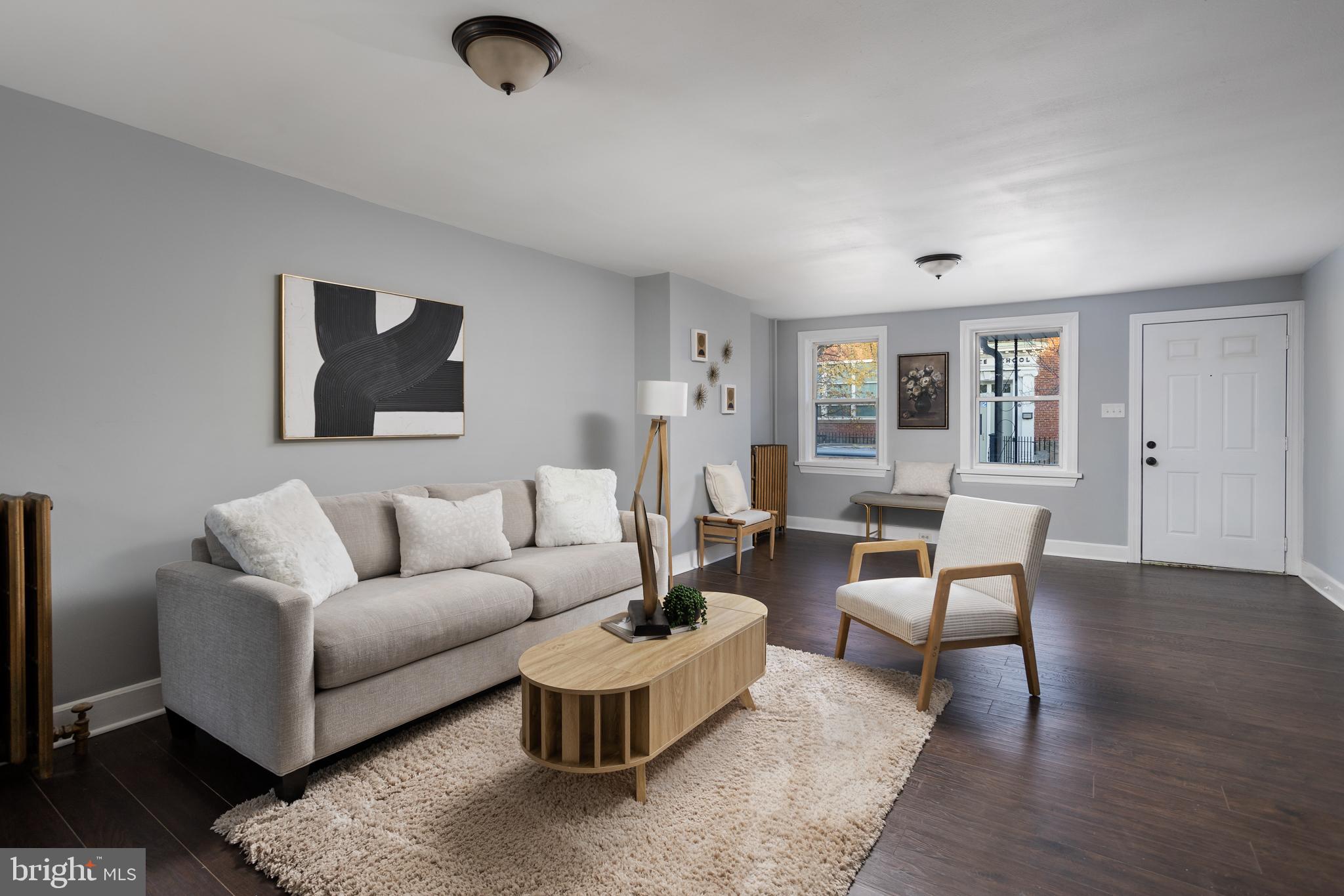 a living room with furniture and wooden floor