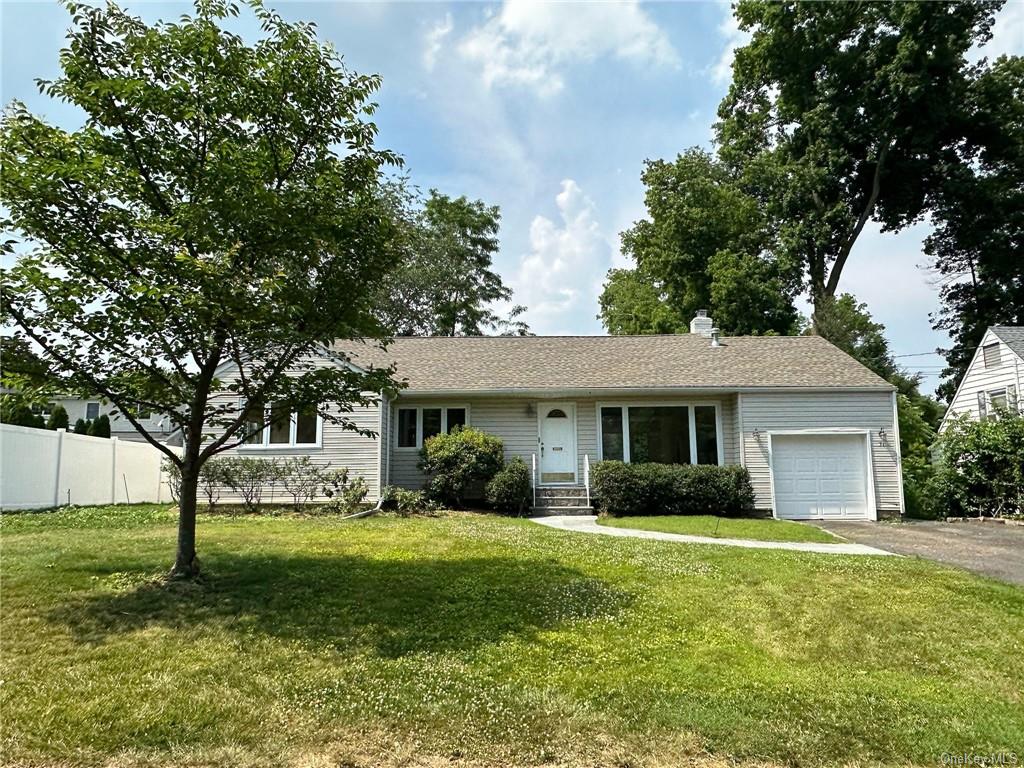 a view of house with a yard