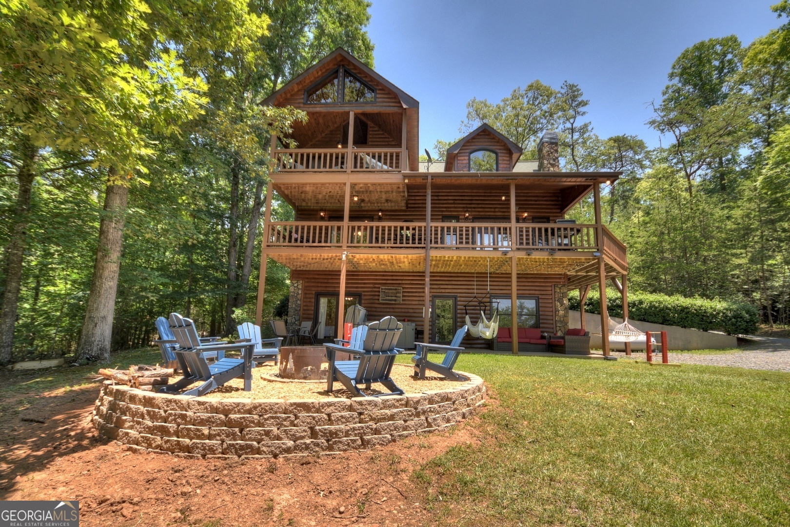 a view of a house with backyard porch and sitting area