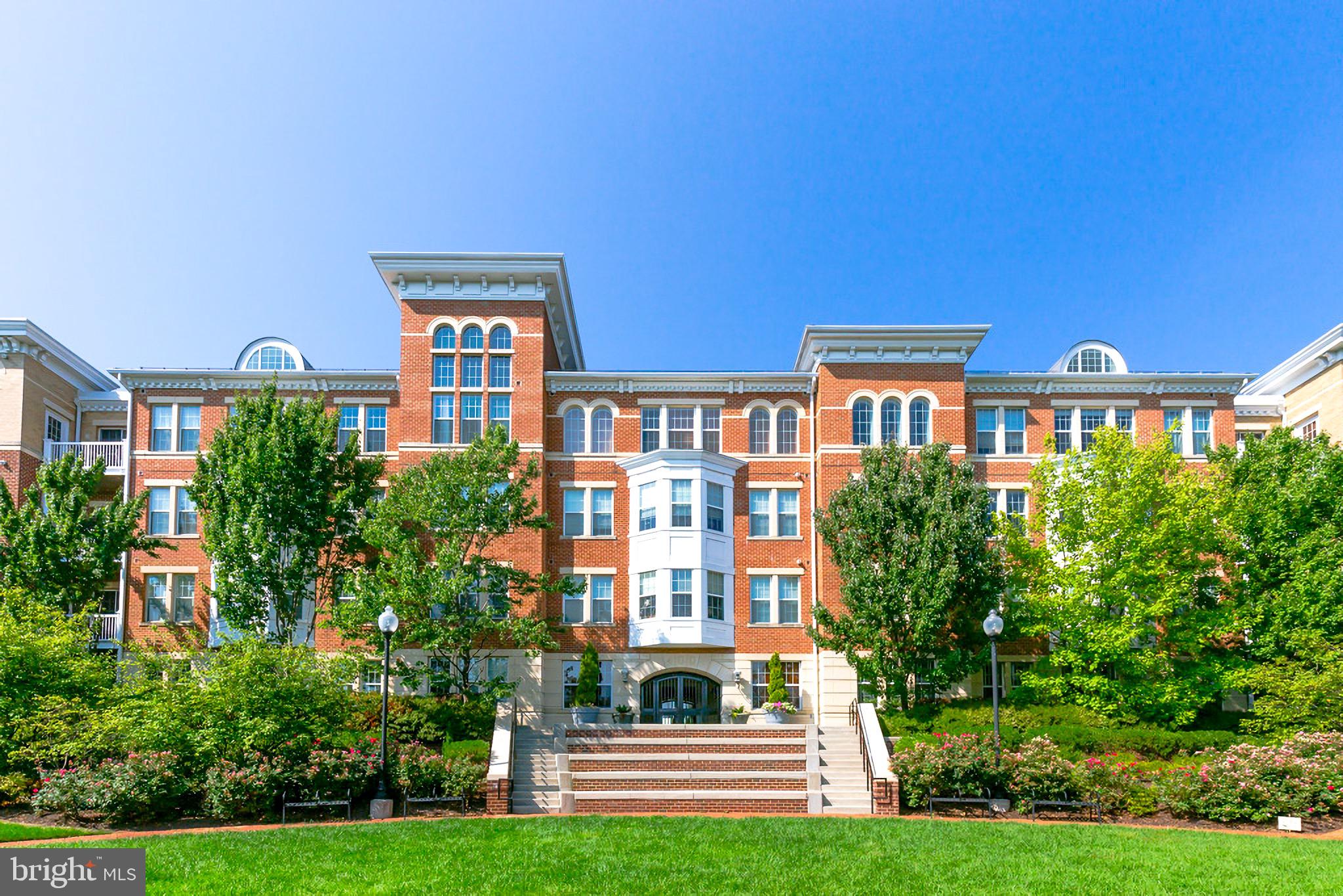 a front view of a residential apartment building with a yard