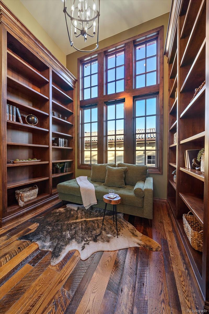 a living room with furniture a rug and a bookshelf