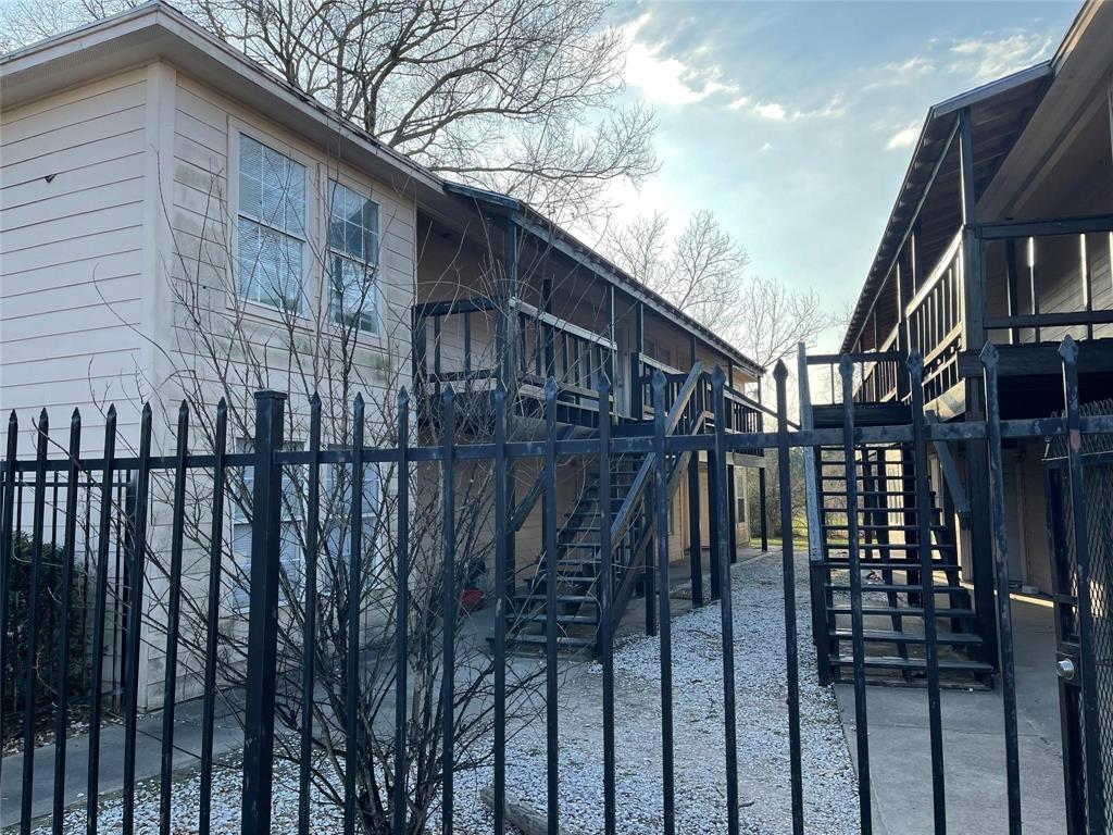 a view of a house with wooden fence