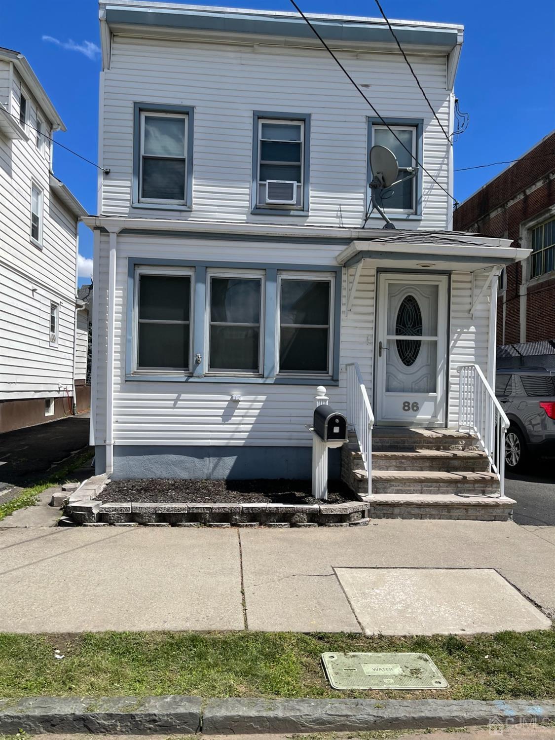 a view of a house with a yard and sitting space