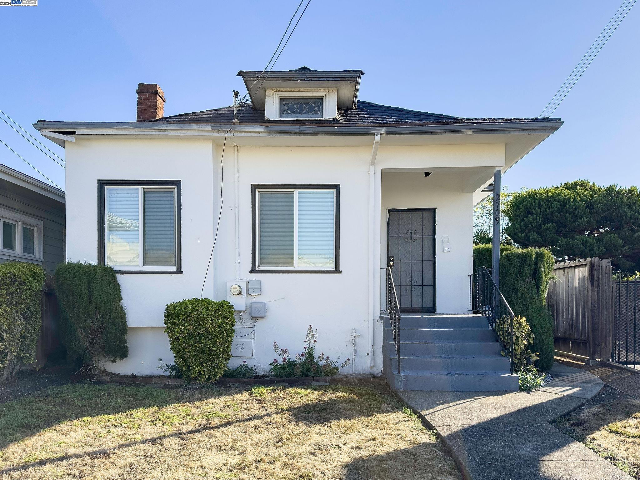 a view of a house with wooden fence