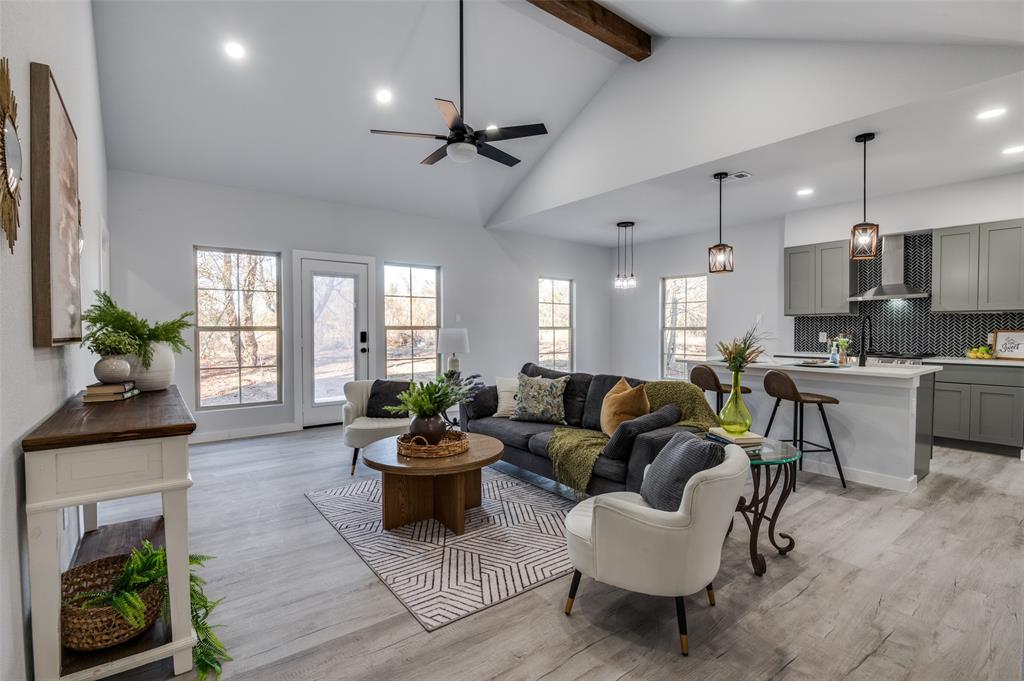 a living room with furniture fireplace and potted plant