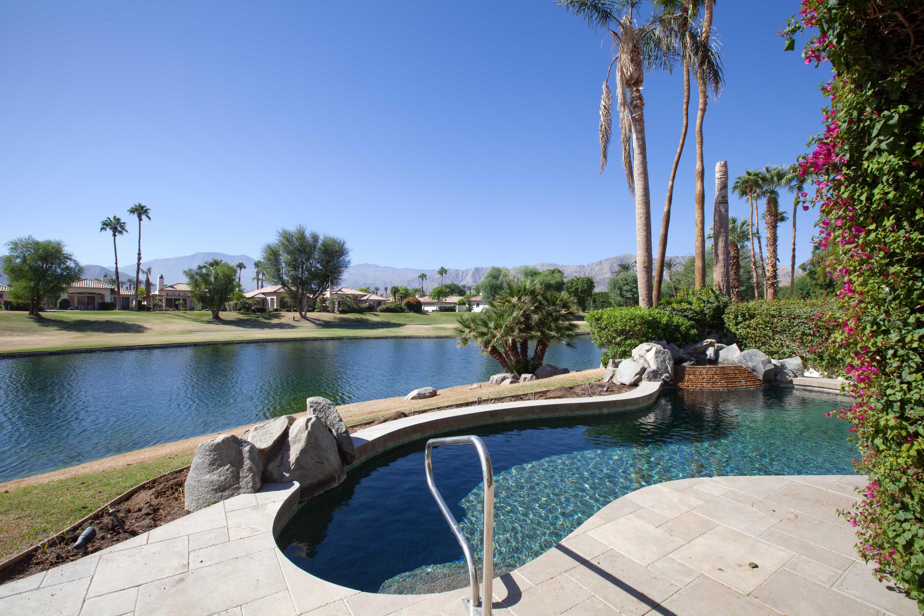 a view of a lake with couches in patio