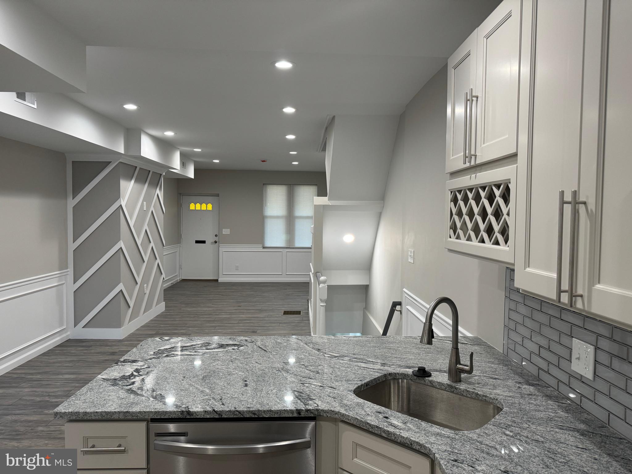 a kitchen with kitchen island a sink stainless steel appliances and cabinets