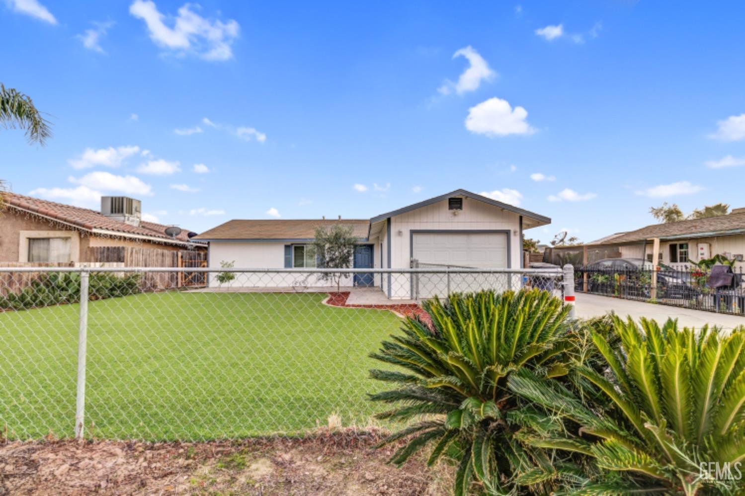 a view of a house with a backyard and a patio