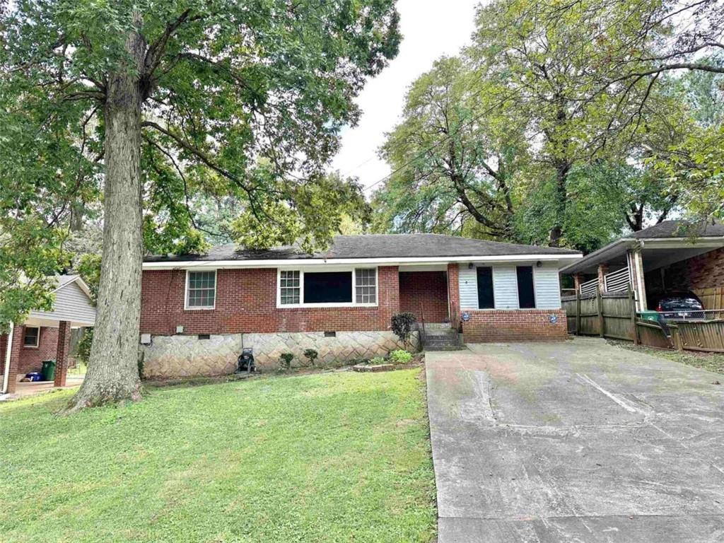 a view of a house with a patio and yard