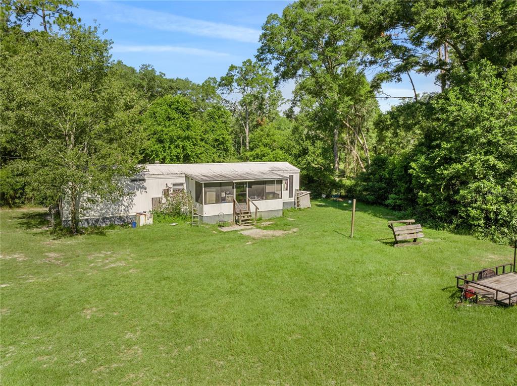 a view of a house with a backyard