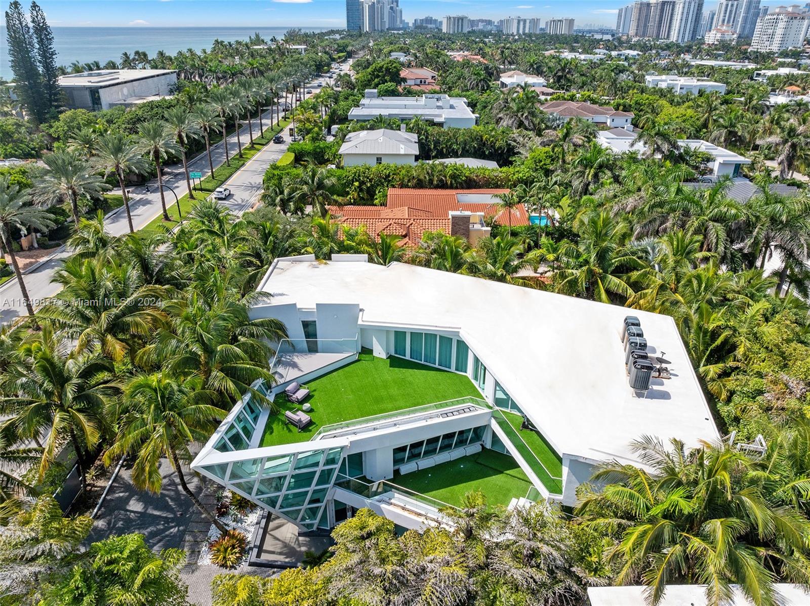 an aerial view of a house with a yard and lake view