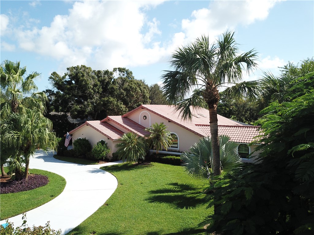 a front view of house with yard and green space