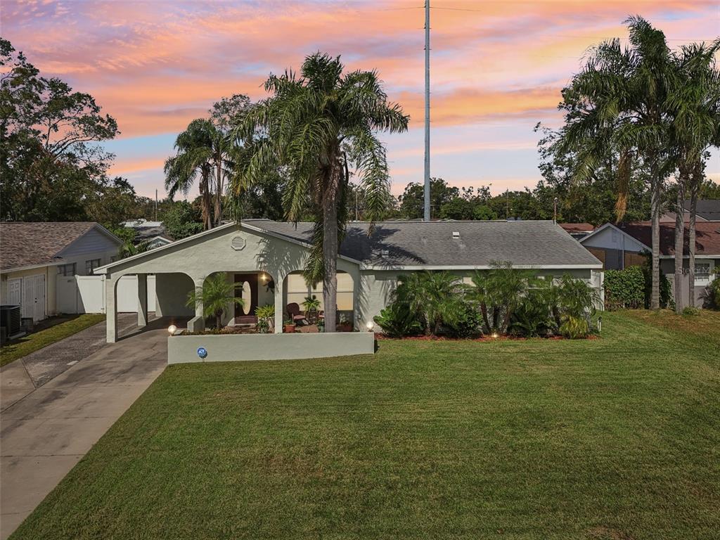 a front view of a house with a garden and yard