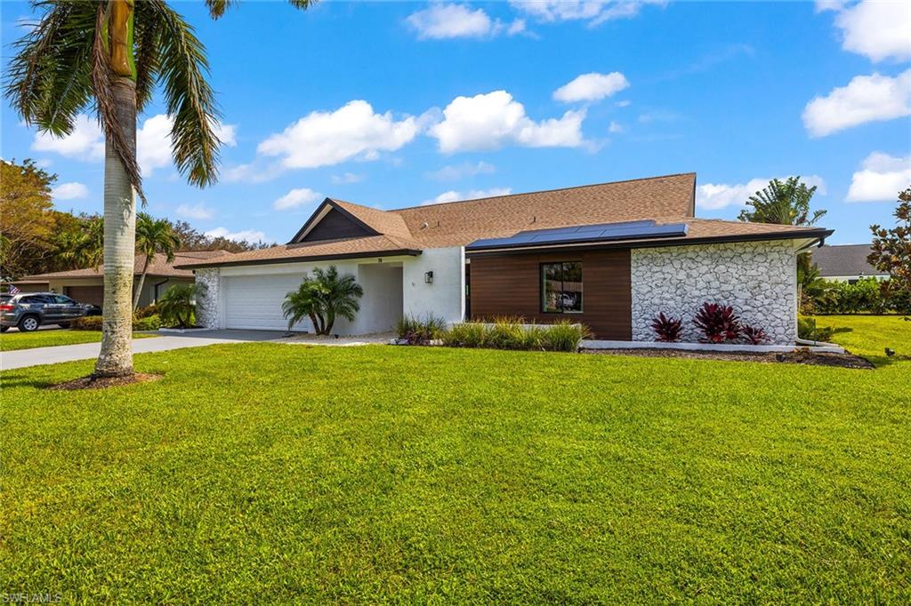 a view of a house with a backyard