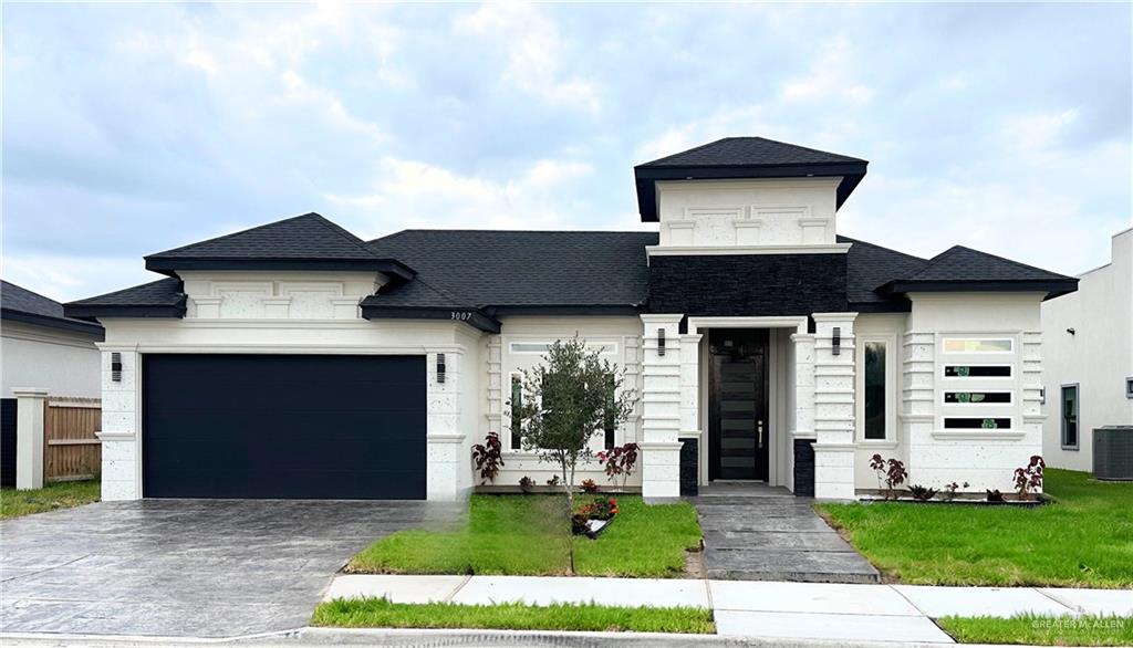 a front view of a house with a garden and yard