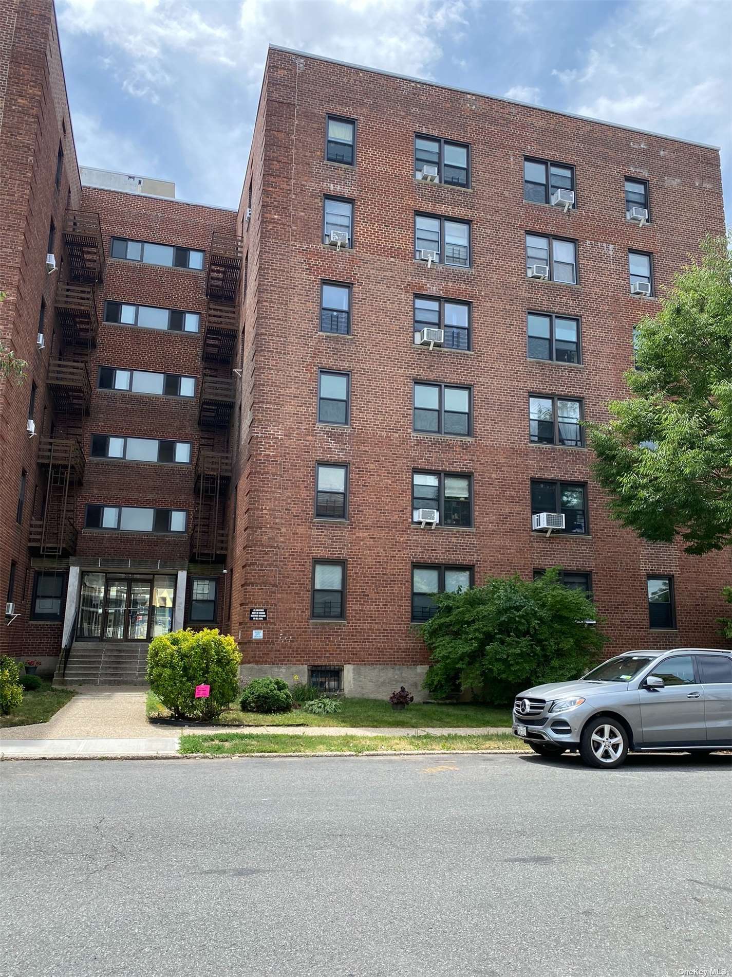 a car parked in front of a brick building