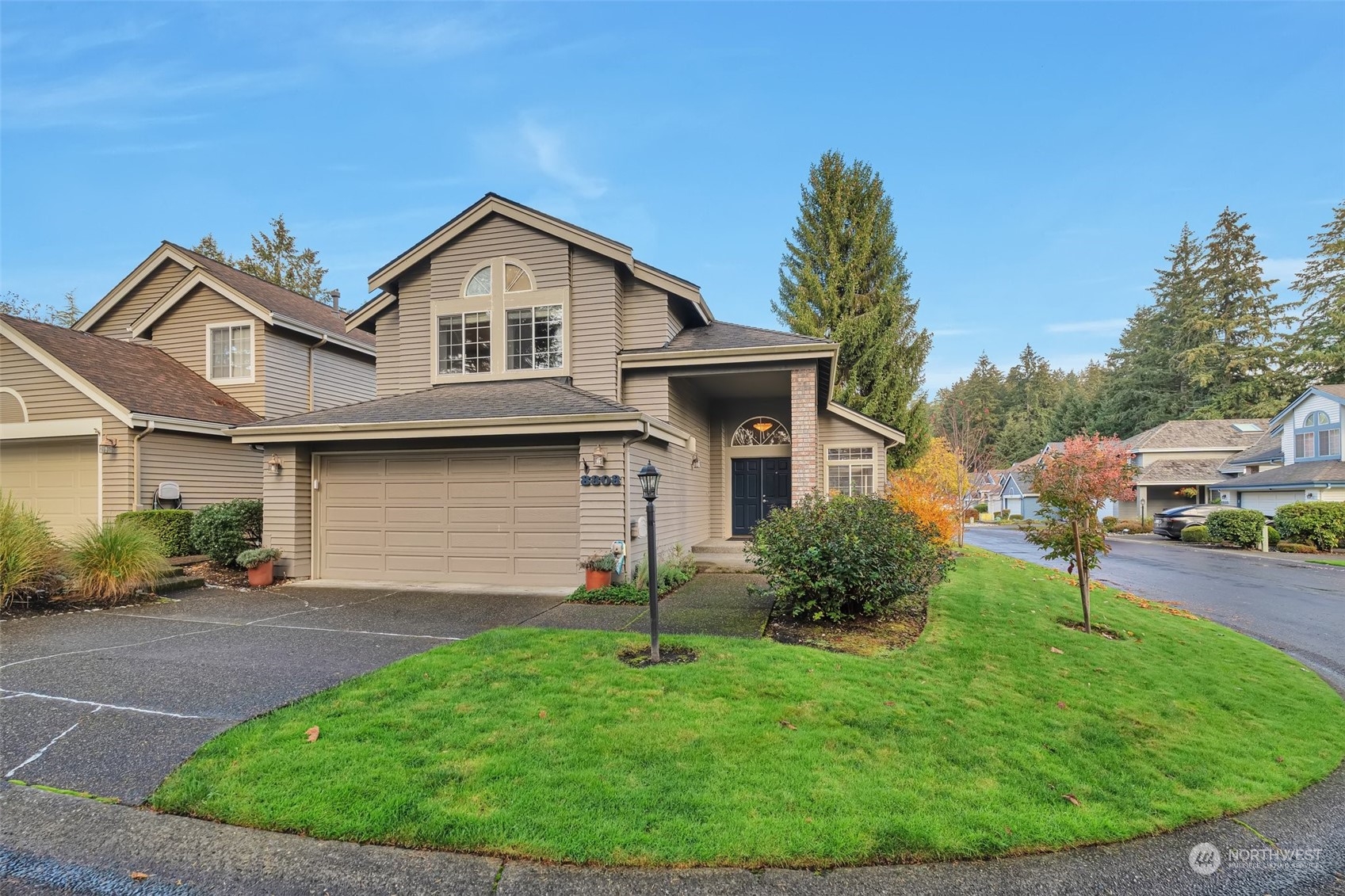 a front view of a house with a yard and garage