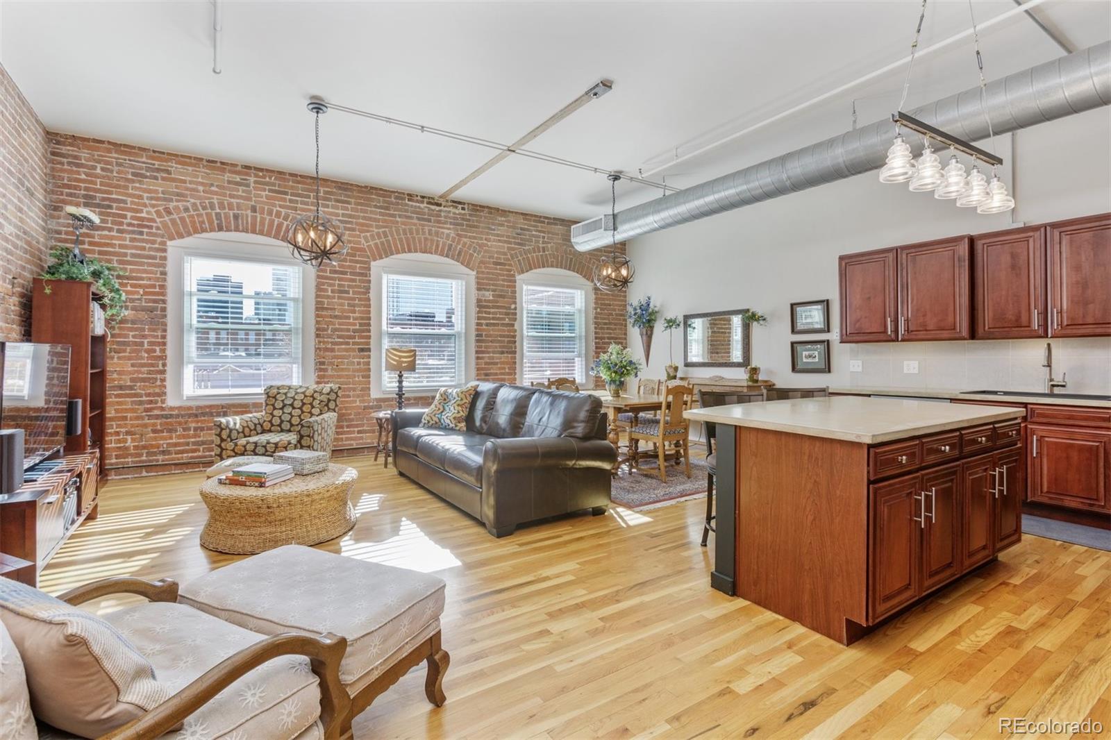 a large living room with stainless steel appliances granite countertop a stove and a view of living room