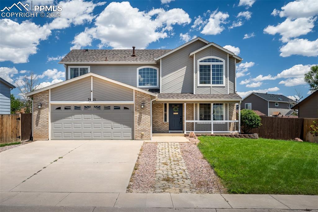 a front view of a house with a yard