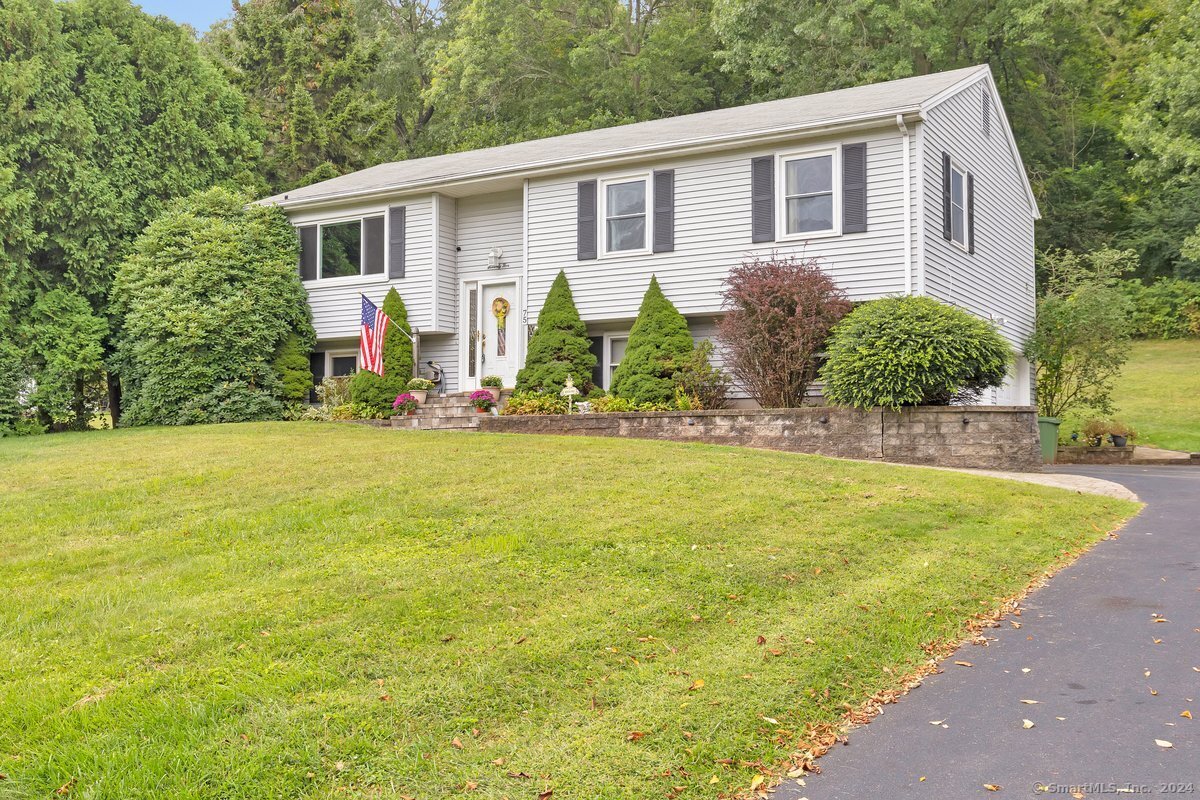 a front view of house with yard outdoor seating and barbeque oven