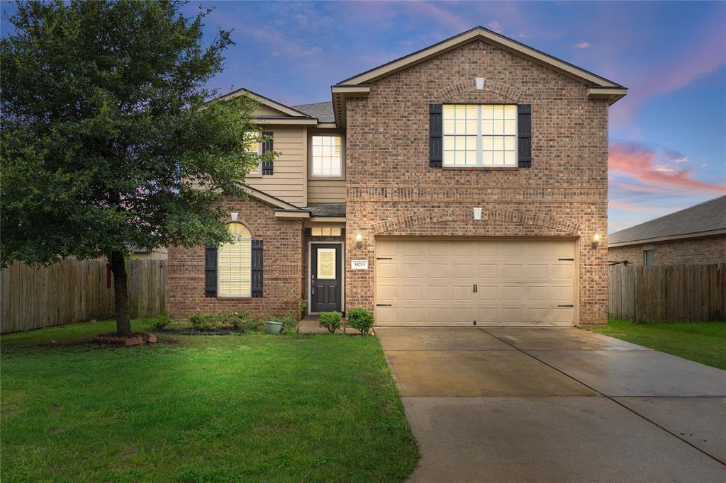 a front view of a house with a yard and garage