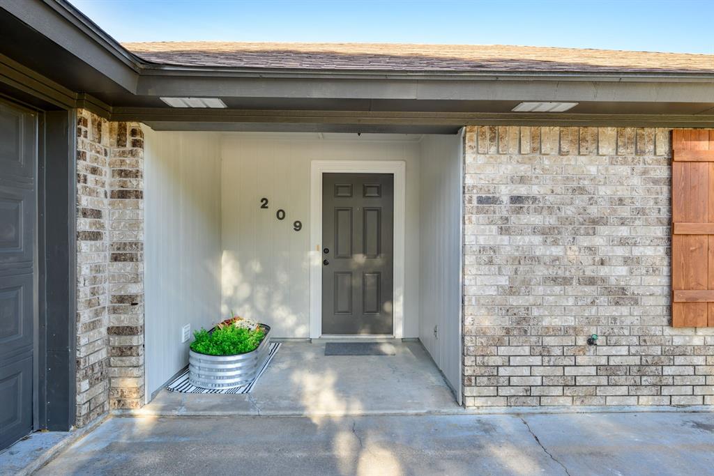 View of the freshly painted entrance to property. Room for small seating area or planters.