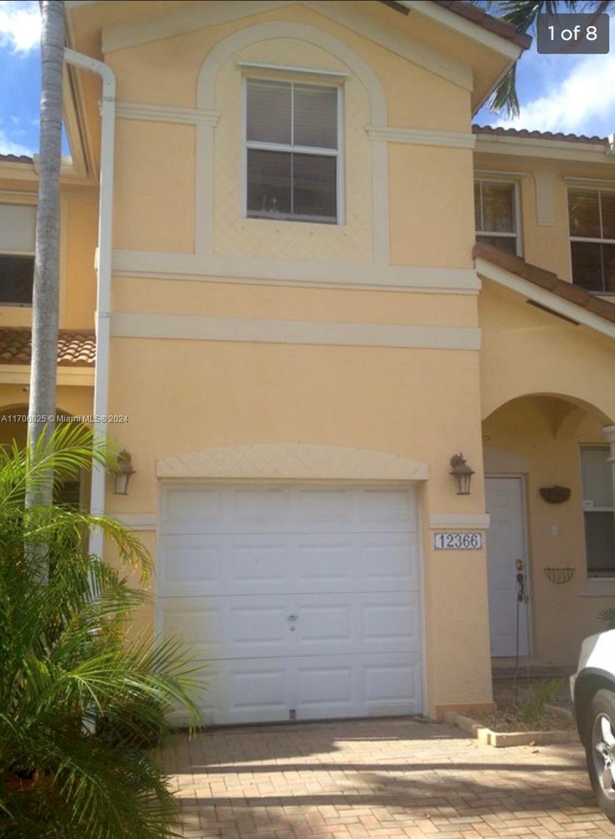 a front view of a house with garage