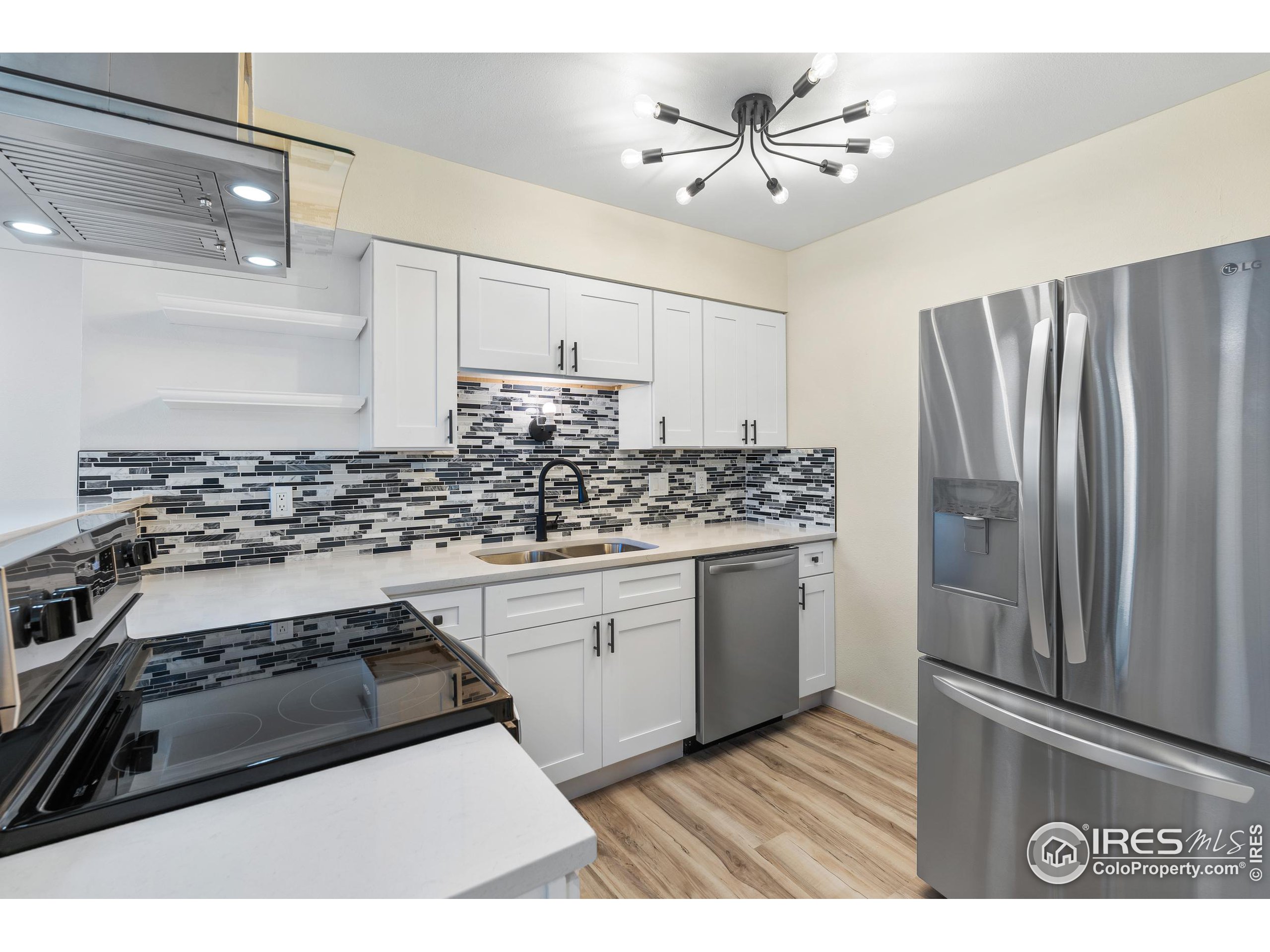 a kitchen with stainless steel appliances a sink stove and refrigerator