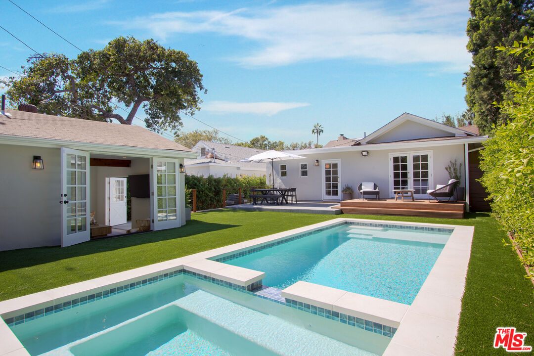 a view of an house with swimming pool and yard