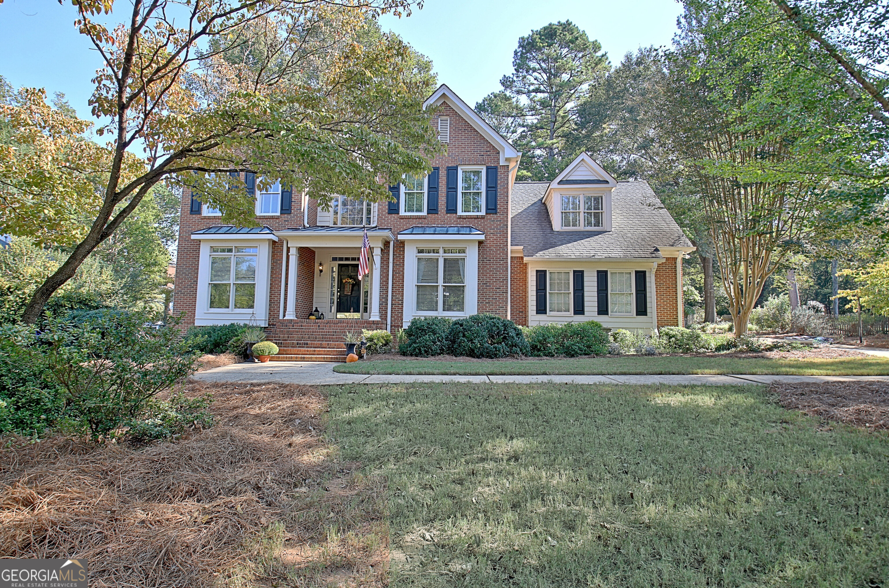 a front view of a house with a garden