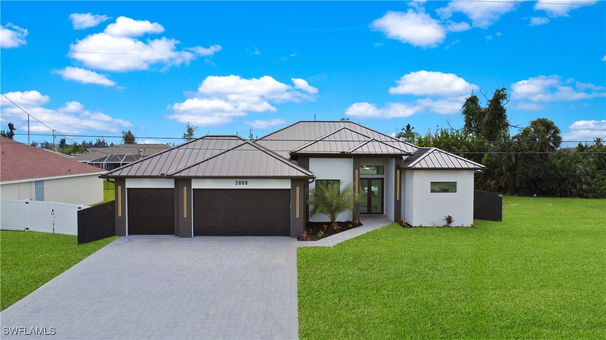 a front view of a house with yard and garage