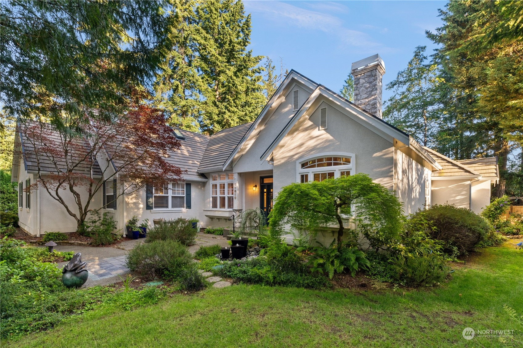 a front view of a house with a garden