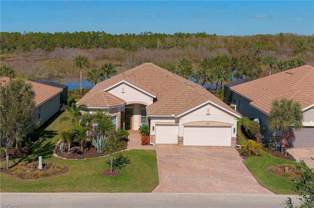 View of front of house featuring a garage and a front yard