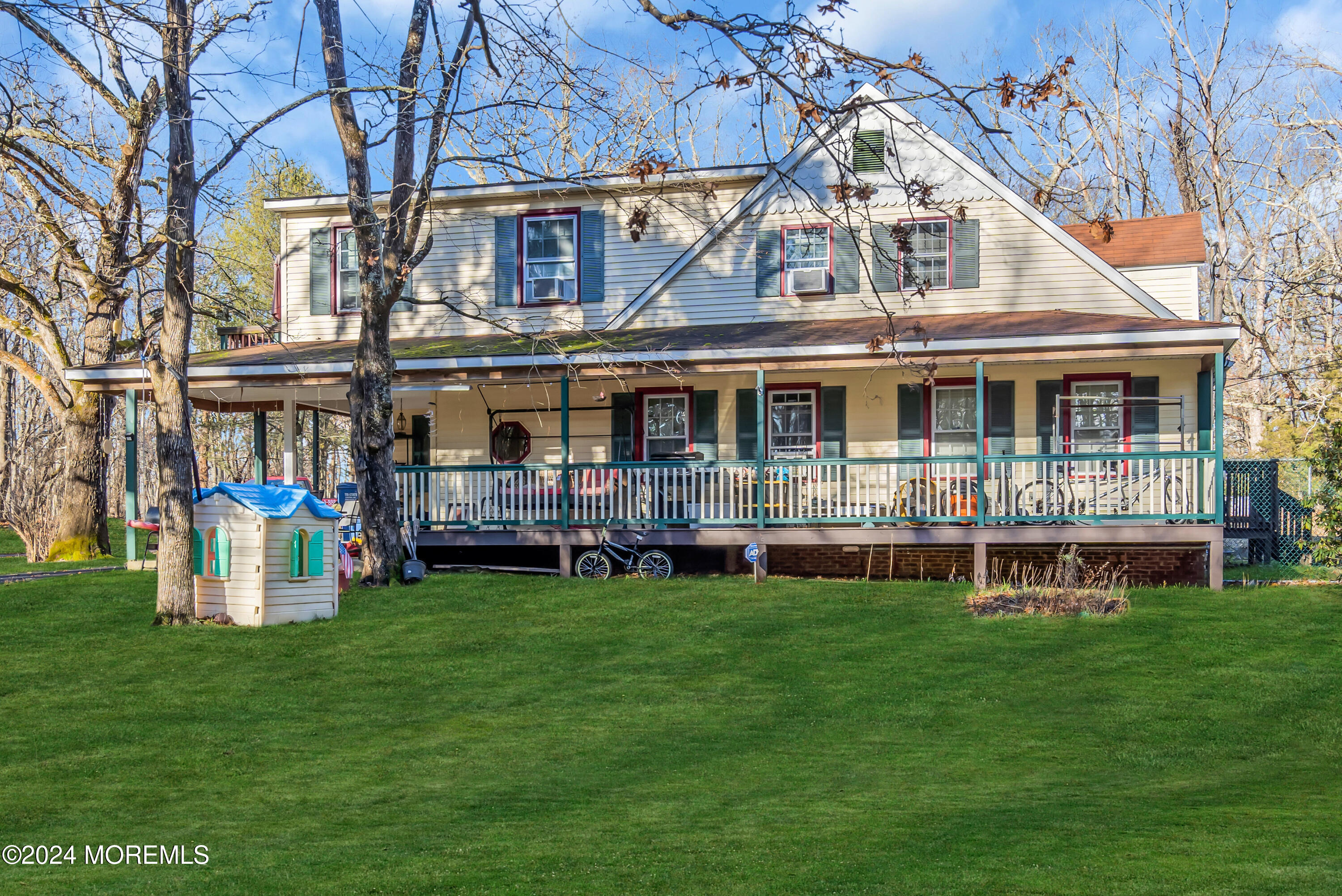 a view of a house with a yard balcony and sitting area