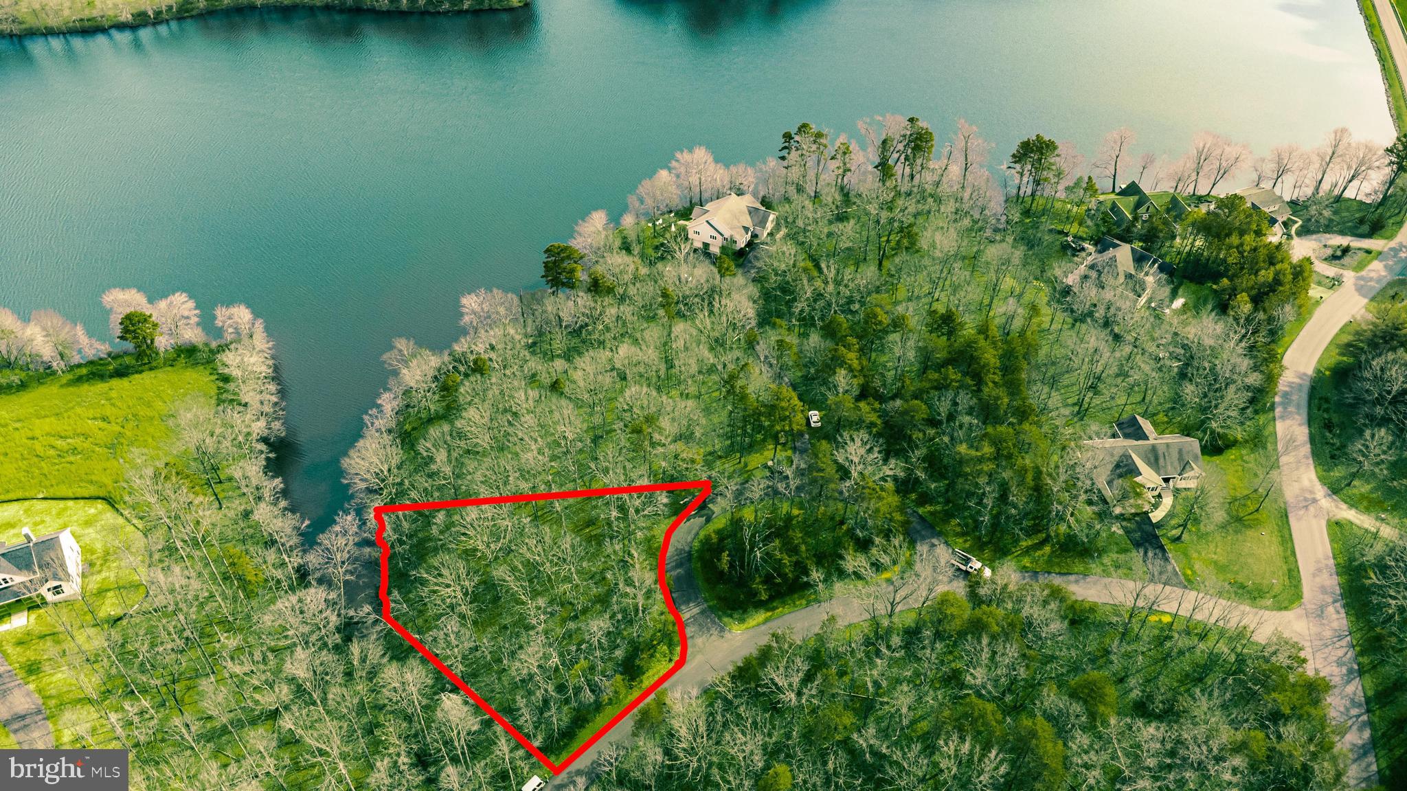 an aerial view of a house with a lake view