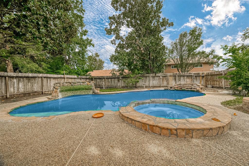 a view of a swimming pool with an outdoor seating