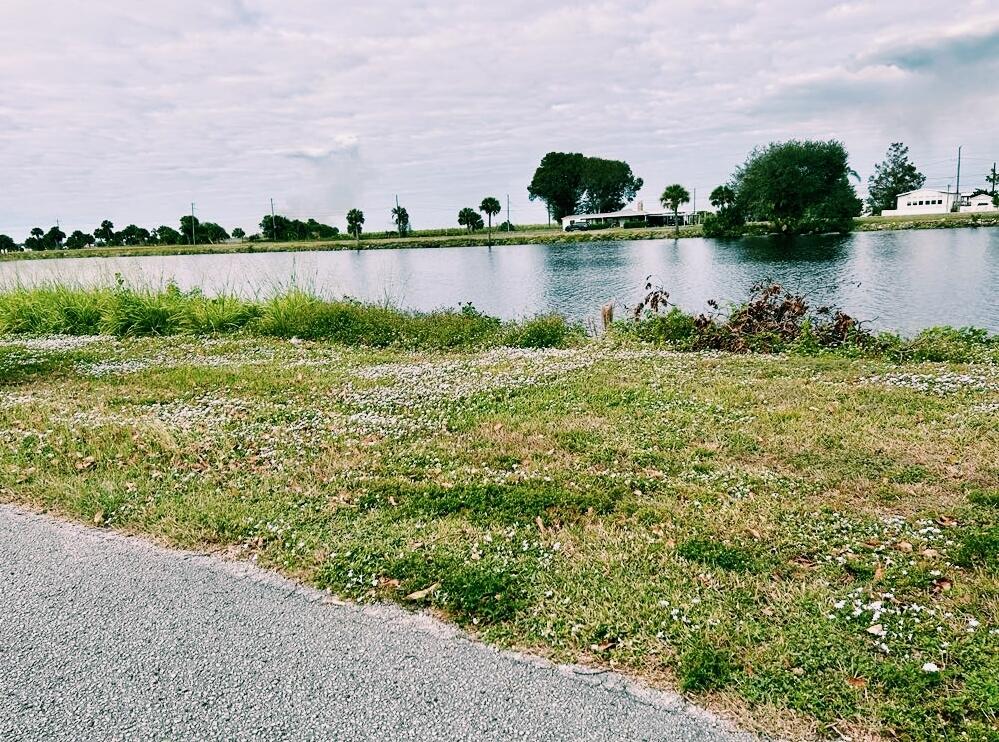 a view of a lake with houses in the back