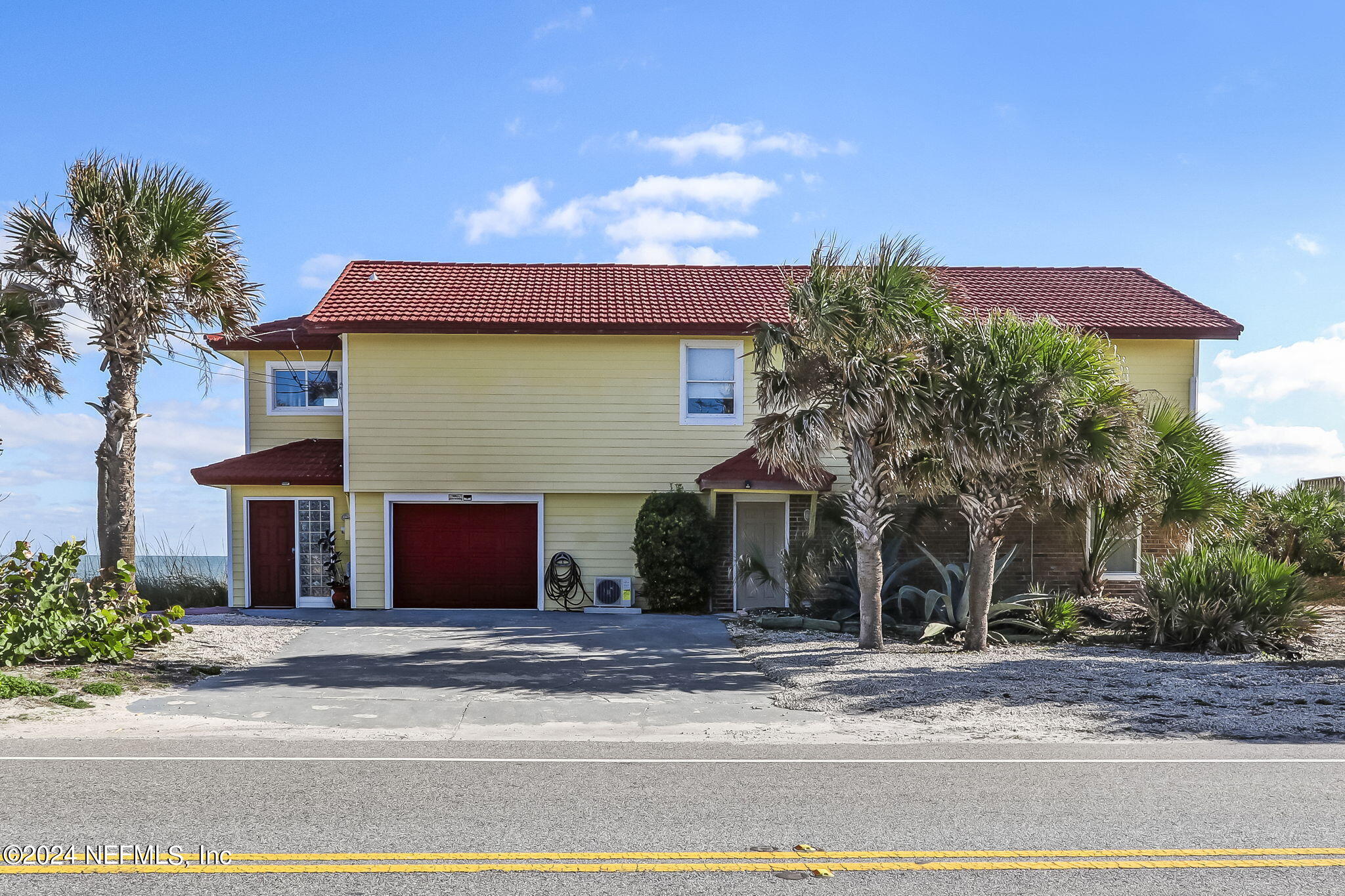 a view of a house with a yard and garage